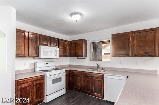 kitchen featuring dark hardwood / wood-style flooring, white appliances, dark brown cabinetry, and sink