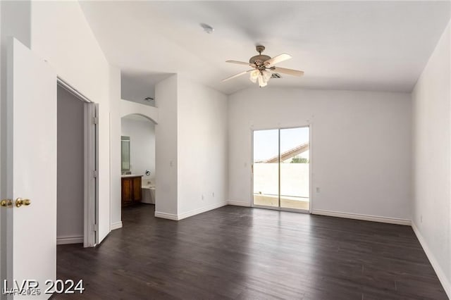 empty room featuring dark hardwood / wood-style floors, ceiling fan, and lofted ceiling