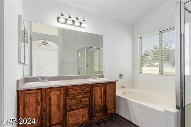 bathroom featuring ceiling fan, wood-type flooring, shower with separate bathtub, and vanity