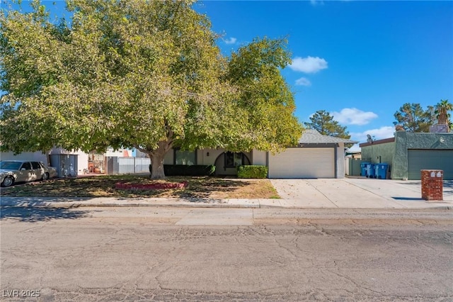 view of property hidden behind natural elements with a garage