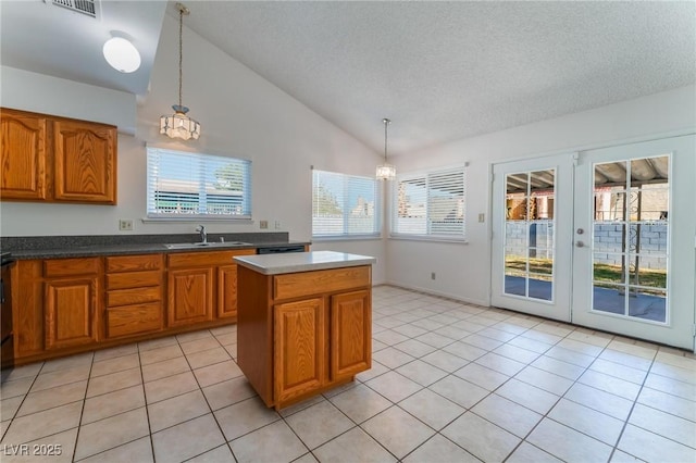 kitchen featuring sink, a kitchen island, pendant lighting, and lofted ceiling