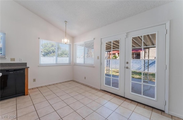 doorway with french doors, a notable chandelier, a textured ceiling, lofted ceiling, and light tile patterned flooring