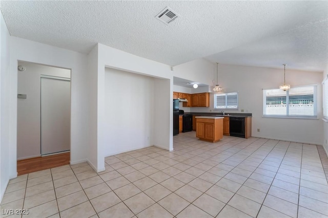 kitchen with black appliances, light tile patterned floors, hanging light fixtures, and vaulted ceiling