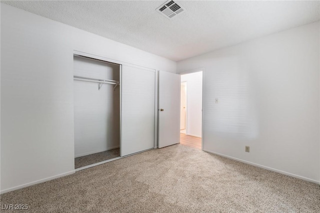 unfurnished bedroom featuring carpet floors and a closet