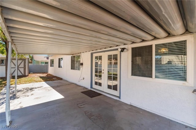 view of patio with french doors and a storage shed