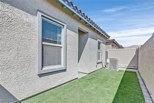 view of property exterior featuring a yard and central air condition unit