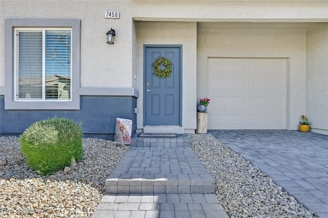 view of exterior entry featuring a garage