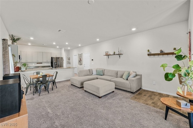 living room with light hardwood / wood-style flooring