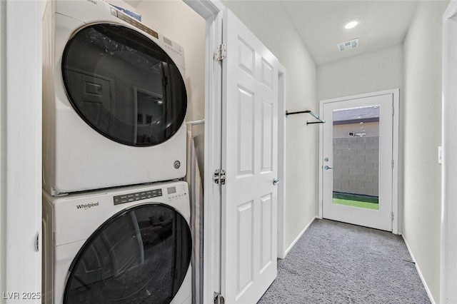 laundry area with light carpet and stacked washer and dryer