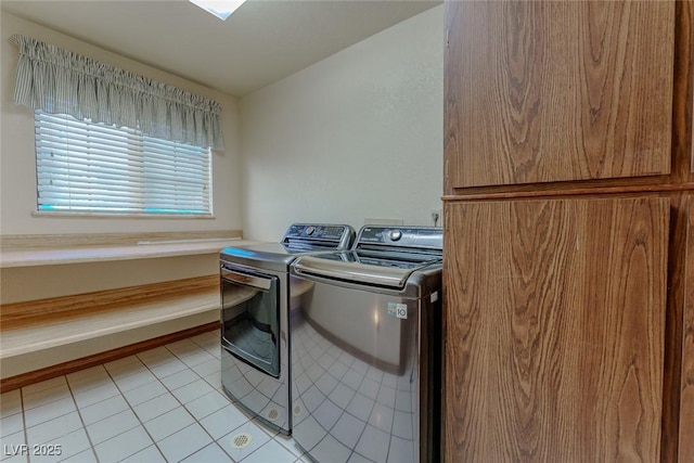 washroom with washer and dryer, laundry area, baseboards, and light tile patterned floors