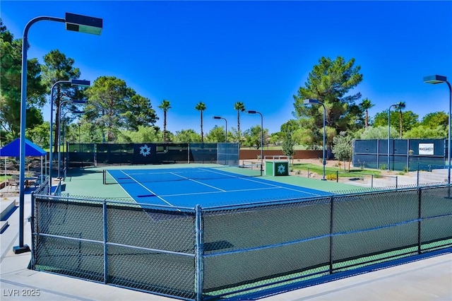 view of tennis court with fence