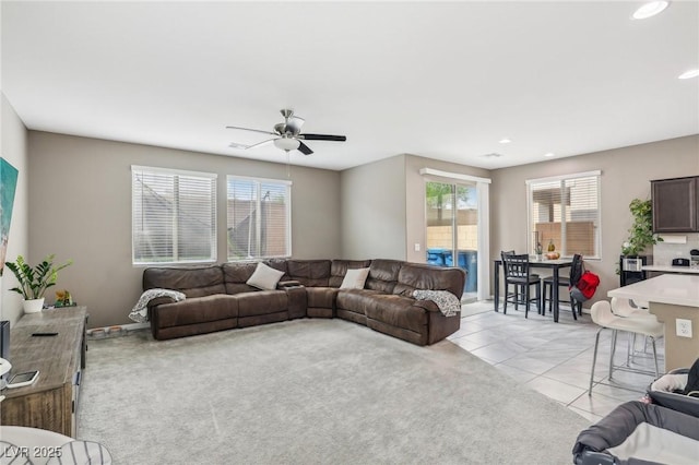 living room with light tile patterned floors and ceiling fan