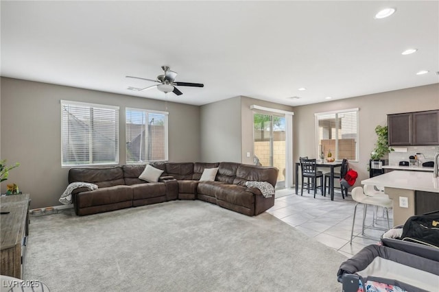 tiled living room with ceiling fan