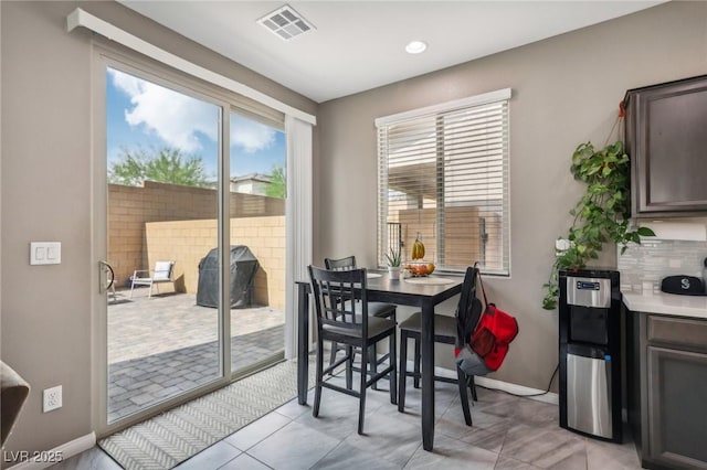 dining area featuring light tile patterned flooring