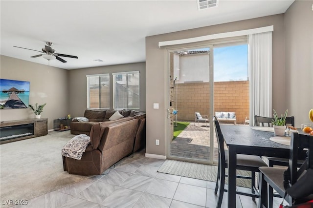 carpeted living room featuring ceiling fan