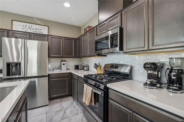 kitchen with decorative backsplash, appliances with stainless steel finishes, and dark brown cabinets