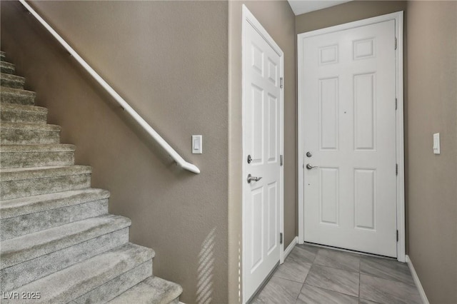 staircase with tile patterned flooring