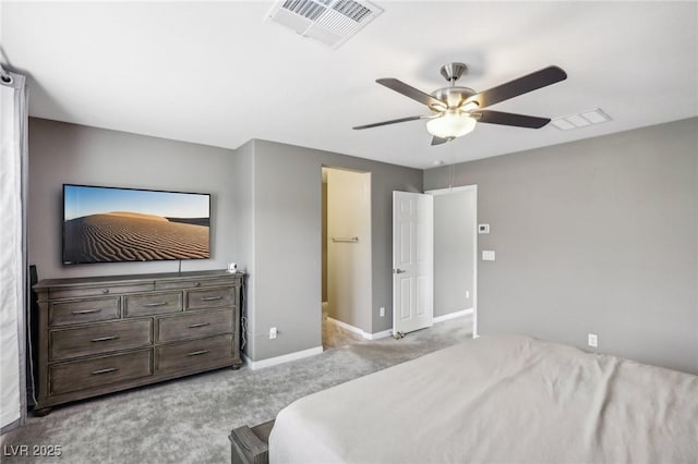 bedroom featuring ceiling fan, light colored carpet, and a spacious closet