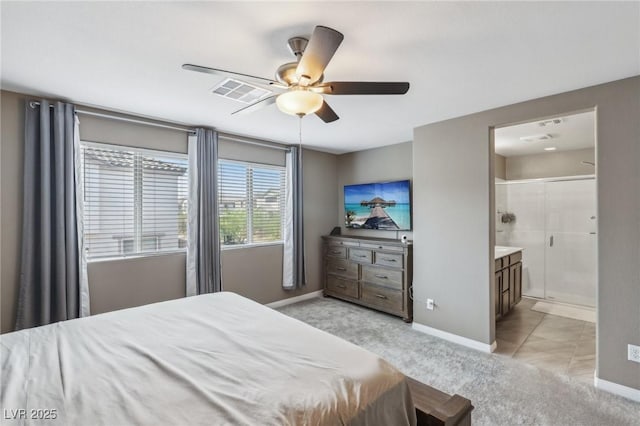 bedroom featuring ensuite bath, ceiling fan, and light colored carpet