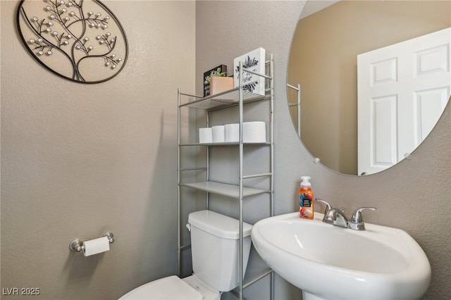 bathroom featuring sink and toilet