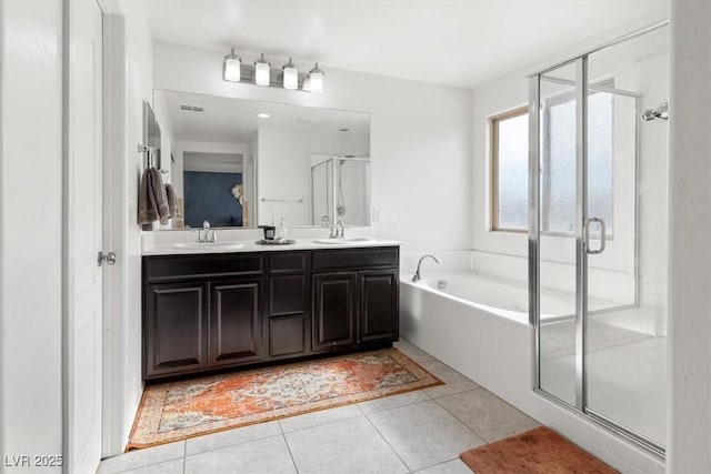 bathroom featuring tile patterned floors, vanity, and plus walk in shower