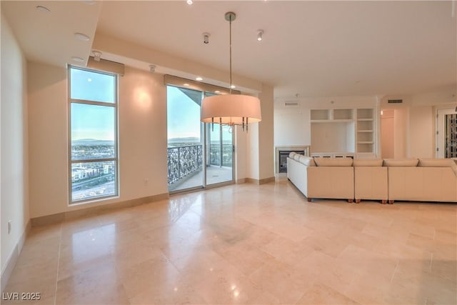 unfurnished living room featuring a wall of windows