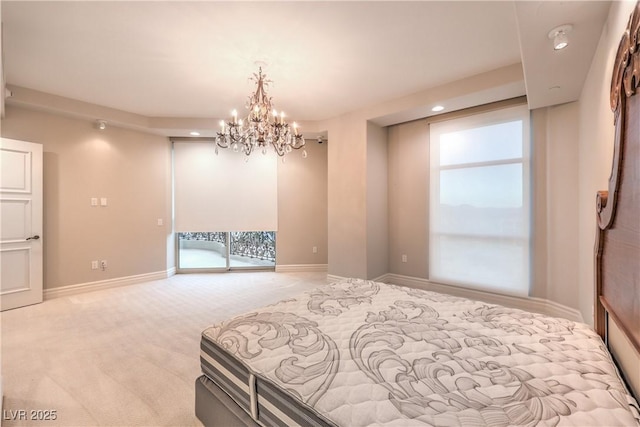 carpeted bedroom featuring access to exterior and an inviting chandelier