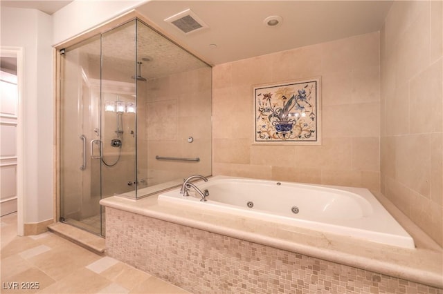 bathroom with tile patterned flooring, tile walls, and independent shower and bath