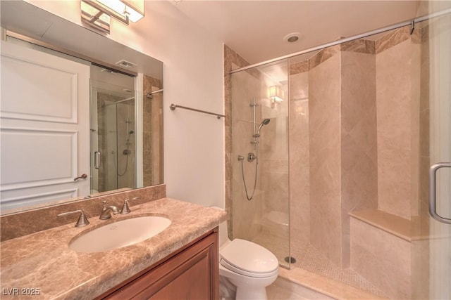 bathroom with vanity, an enclosed shower, and toilet