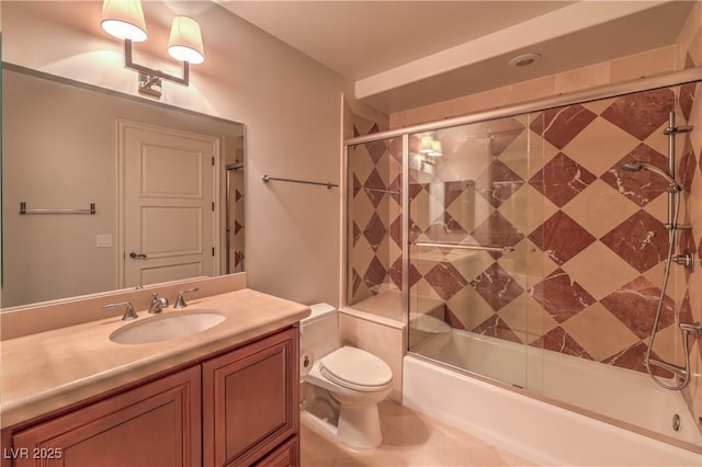 full bathroom featuring vanity, toilet, and combined bath / shower with glass door