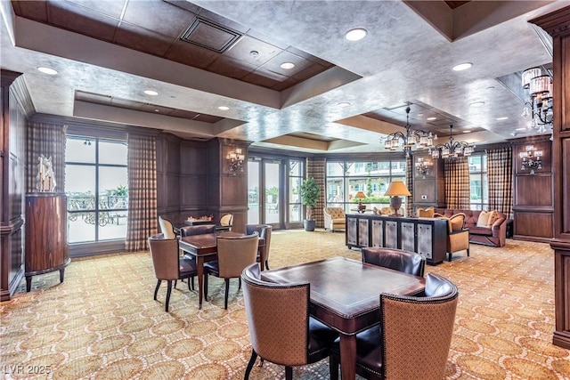 carpeted dining room featuring a raised ceiling