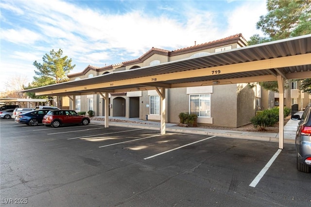 view of parking / parking lot featuring a carport