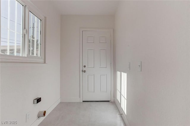 doorway with plenty of natural light and light tile patterned floors