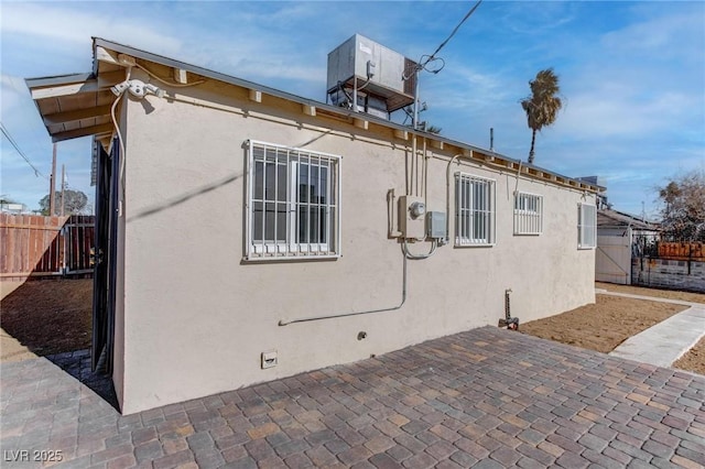 view of side of home with a patio area