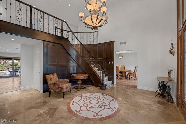 entrance foyer with a towering ceiling and an inviting chandelier