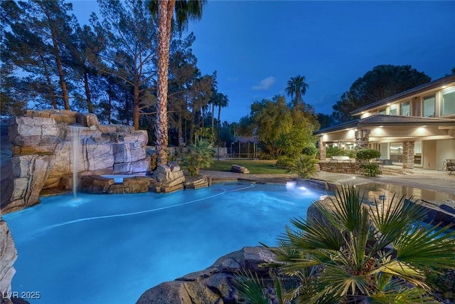 view of pool at dusk