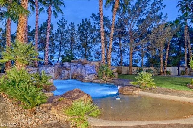 view of pool featuring a lawn