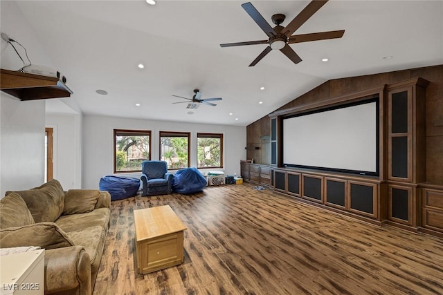 home theater featuring hardwood / wood-style floors, ceiling fan, and lofted ceiling