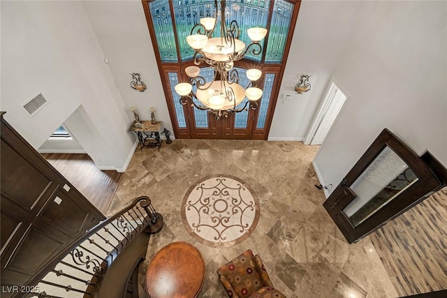 foyer entrance featuring a notable chandelier and a high ceiling