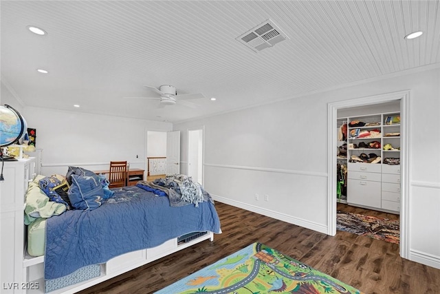 bedroom with crown molding, ceiling fan, and dark wood-type flooring