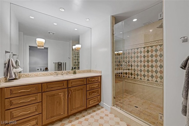 bathroom featuring vanity and a shower with door