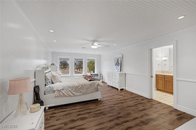 bedroom featuring connected bathroom, crown molding, ceiling fan, and dark wood-type flooring