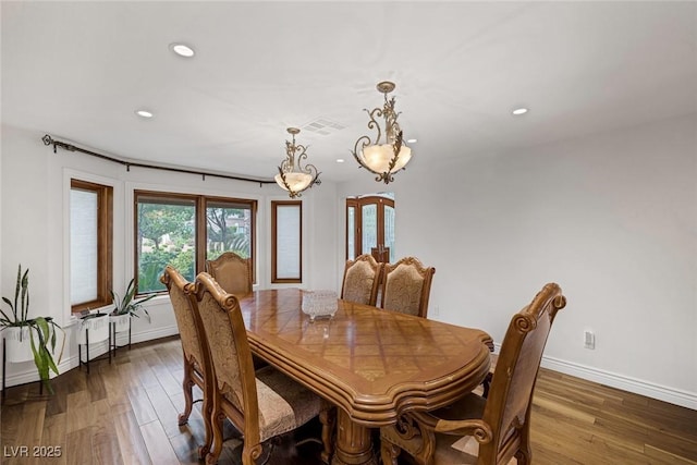 dining space with dark hardwood / wood-style floors