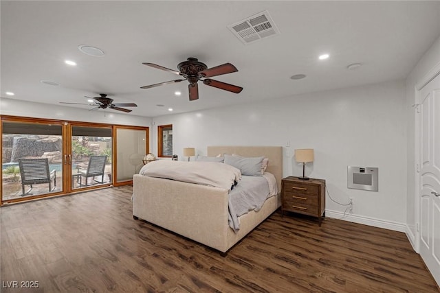 bedroom featuring access to exterior, dark hardwood / wood-style flooring, heating unit, and ceiling fan