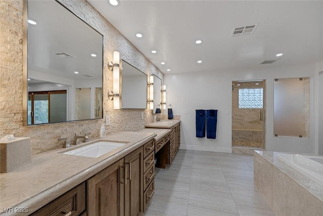 bathroom featuring plenty of natural light, vanity, independent shower and bath, and tile patterned flooring