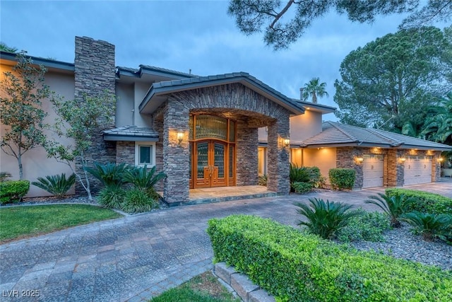 entrance to property with french doors and a garage