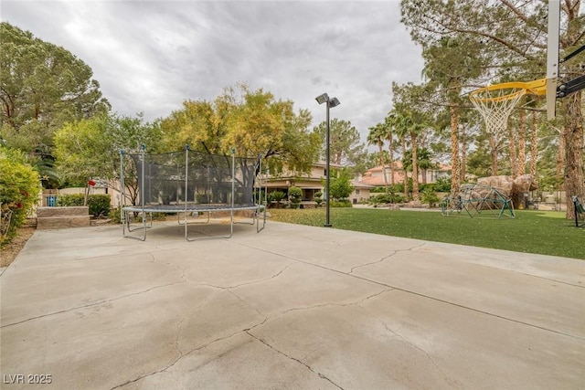 view of home's community with a yard and a trampoline