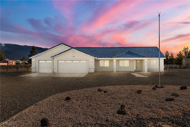 view of front of home with a mountain view and a garage