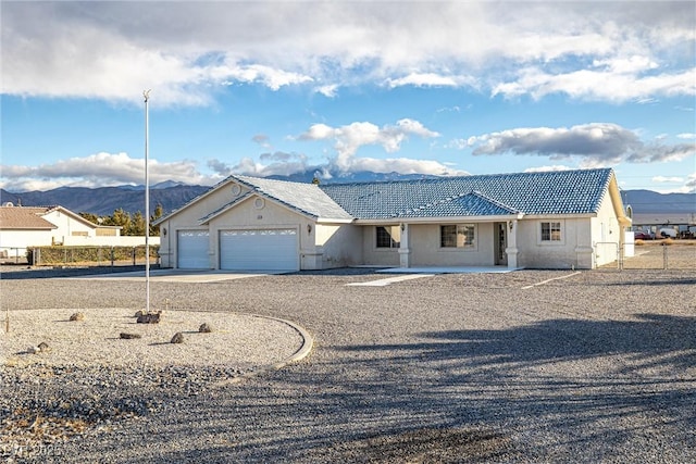 single story home featuring a mountain view and a garage