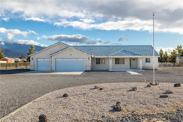 ranch-style home featuring a mountain view and a garage